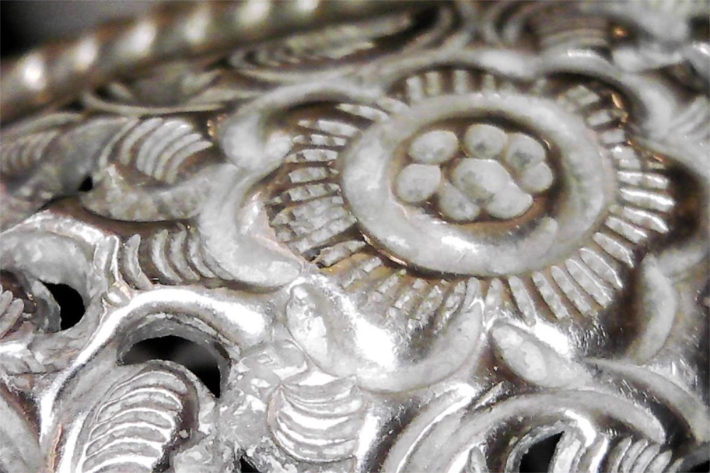 Closeup of flower engraved on Vintage Antique Southeast Asian Silver Repoussé Cuff