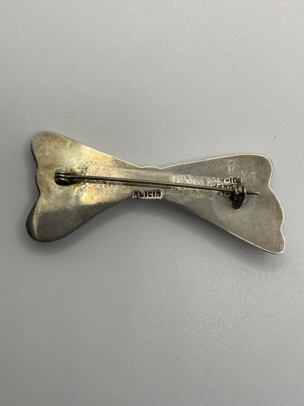 Back of the Authentic Vintage Alicia de la Paz Sterling Silver Bow Brooch with Alicia etched