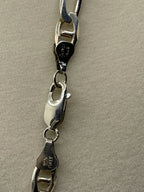 Closeup of the clasp of a Vintage AZ Italy Sterling Silver Figaro Chain Link Necklace 17"