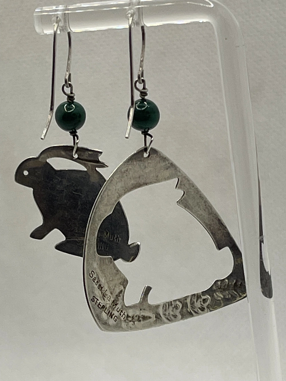 Preowned Sassi LaMuth Sterling Silver Rabbit Cut Out Earrings hanging on a rack