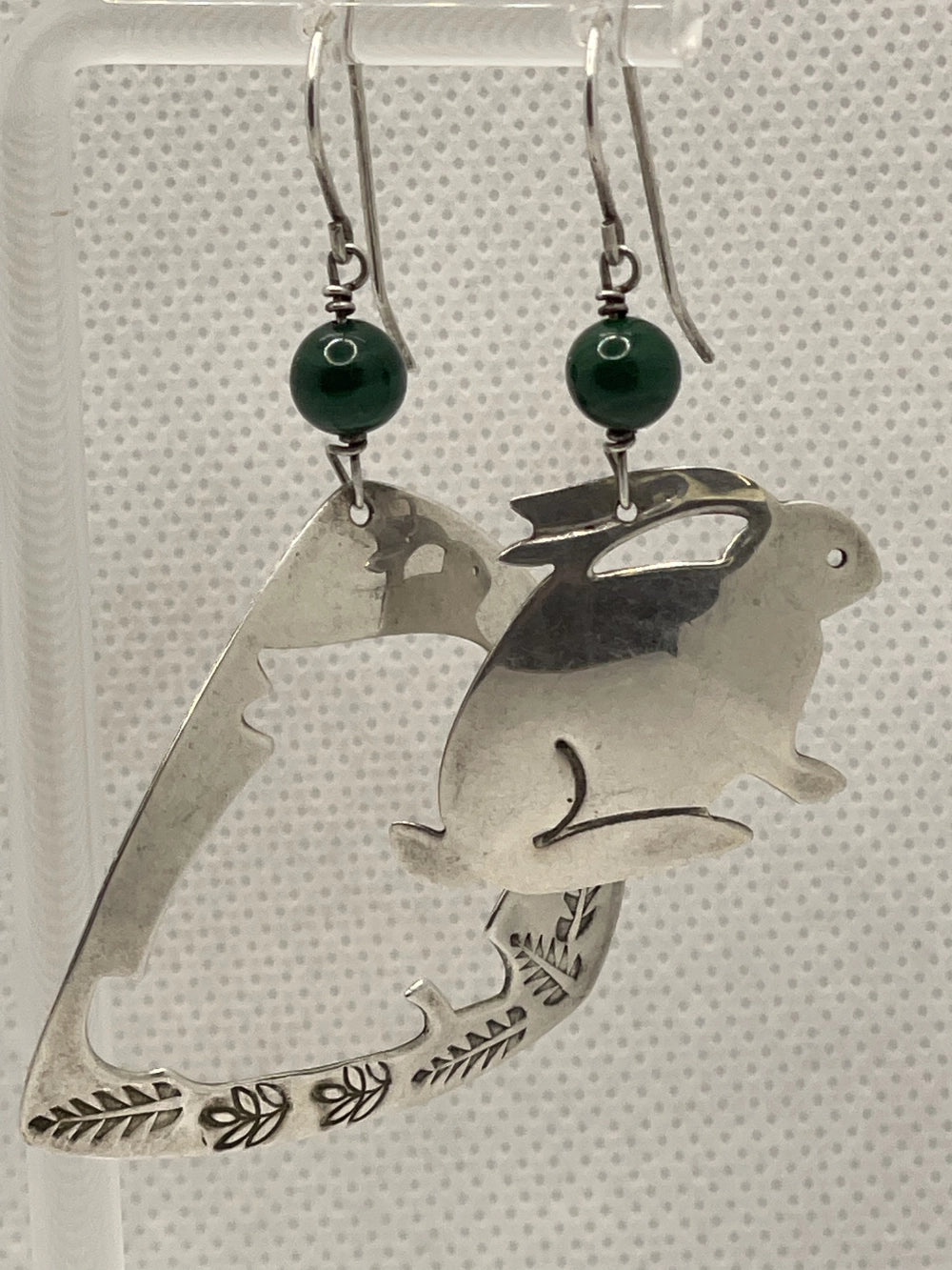 Front VIew of Preowned Sassi LaMuth Sterling Silver Rabbit Cut Out Earrings hanging on a rack