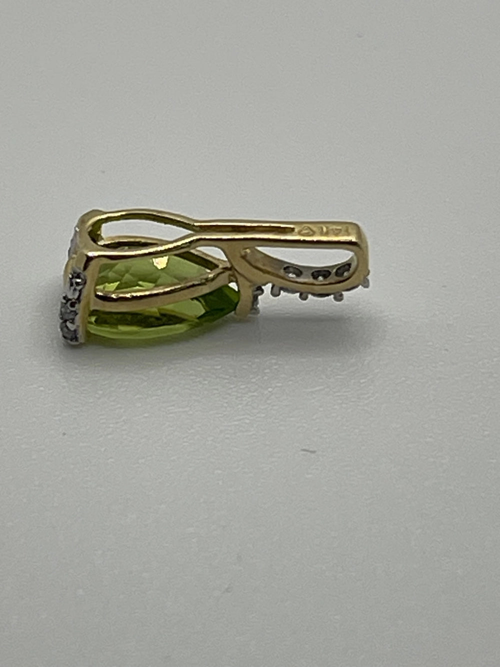 Side view of the Preowned Stuller Pear Shaped Peridot Diamond 14k Gold Pendant