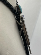 Left side of the Signed Roy Talahaftewa Hopi Sterling Silver Overlay Bolo Tie