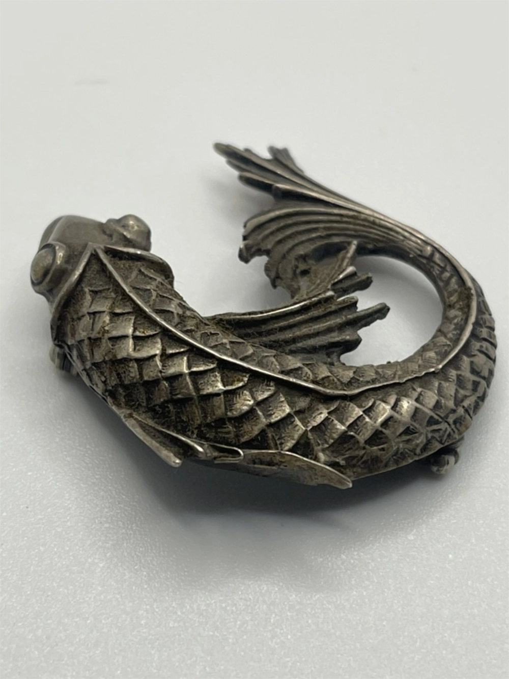 Rotated view of the front of the Vintage 925 Silver Curved Koi Fish Pendant