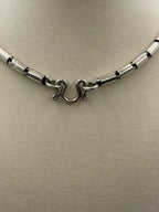 Closeup of the clasp of a Vintage Southwestern Modernist Bench-Made Sterling Silver Linked Tube Chain Necklace