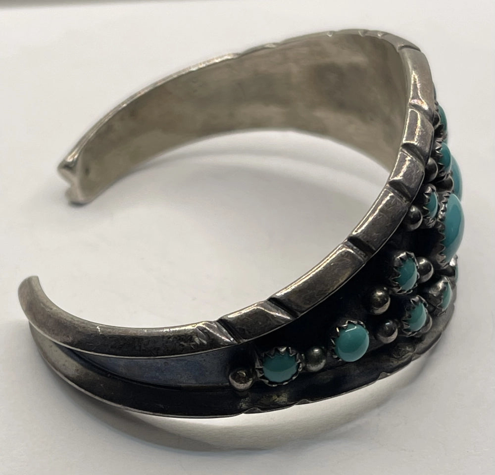 Side view of Vintage Signed Authentic Rose Castillo Native American Navajo Cluster Turquoise and Sterling Cuff Bracelet