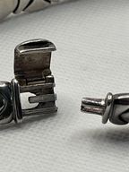 Open metal clasp of a Vintage Garzi Silver And Gold Jewels Two-Tone Collar Necklace Silver and 18k Gold Vermeil