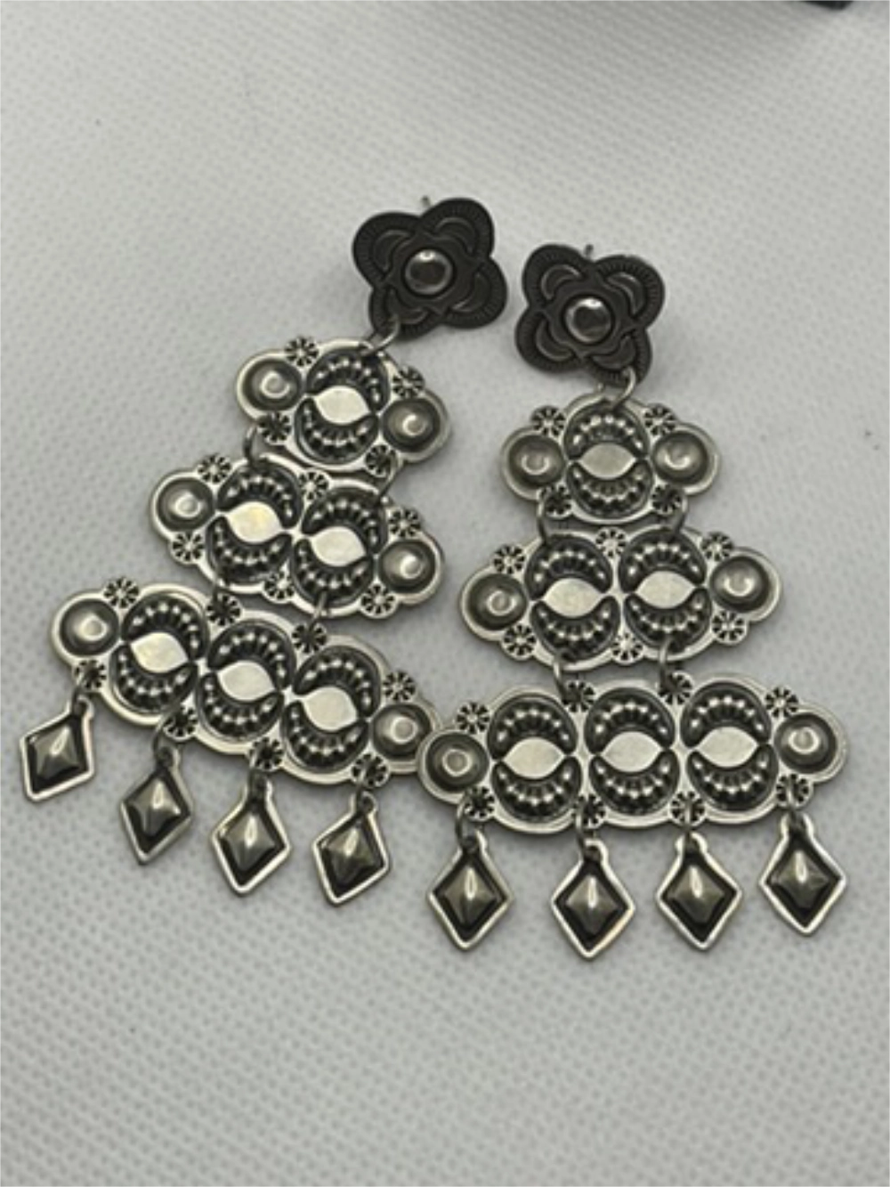 Flat view of the Vintage Harris Joe Sterling Silver Chandelier Repousse Earrings