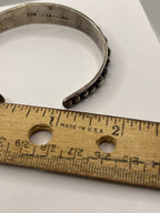 Vintage Anthony Pineda 970 Sterling Silver Modernist Cuff Bracelet next to closeup of ruler