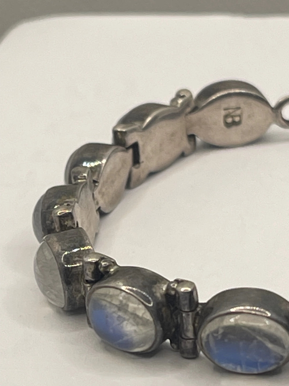 Closeup side view of Vintage Nicky Butler Rainbow Moonstone Link Bracelet with NB etched