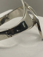 Closeup of the left side of Vintage Genuine Alicia de la Paz Modernist Interlocking Silver Bangle Bracelet