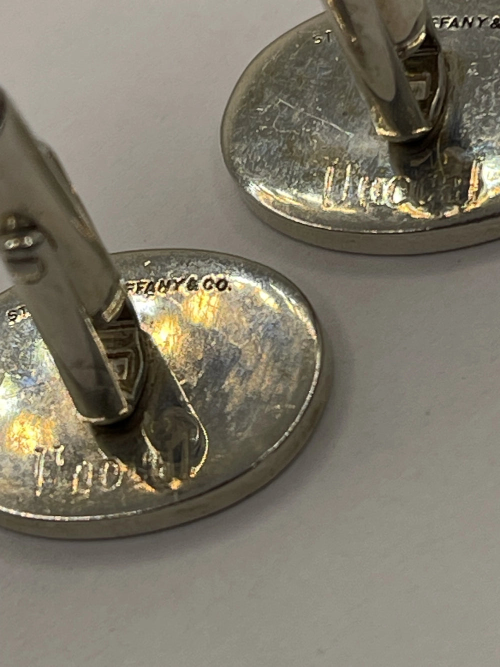 Closeup of back of Vintage  Oval Sterling Silver Cufflinks with Tiffany & Co. etched in the back.