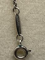 Closeup of the clasp of a Vintage Tiffany & Co. Elsa Peretti Pearl Mesh Tassel Pendant Necklace