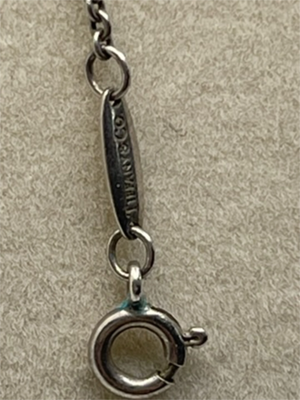 Closeup of the clasp of a Vintage Tiffany & Co. Elsa Peretti Pearl Mesh Tassel Pendant Necklace