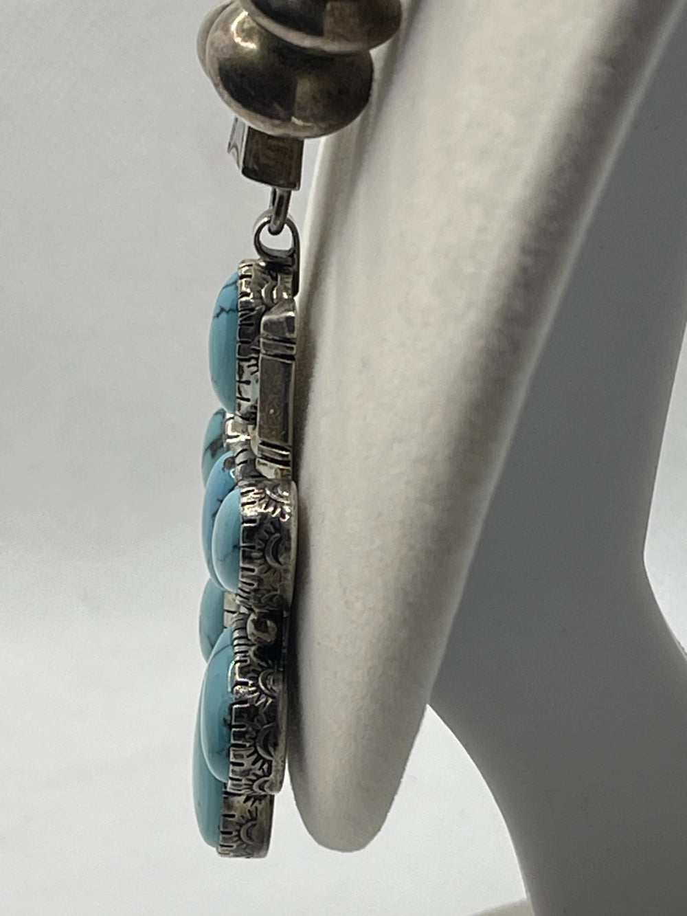 Side view of floral pendant from the Vintage Tom Willeto Signed Turquoise Cluster Cross Necklace