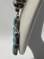 Side view of floral pendant from the Vintage Tom Willeto Signed Turquoise Cluster Cross Necklace